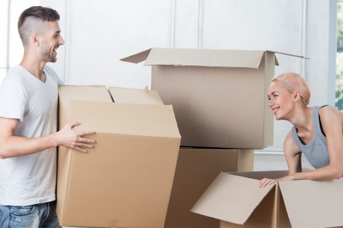 Movers handling boxed belongings carefully during transport